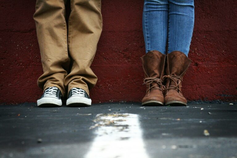 Two people stand facing each other.