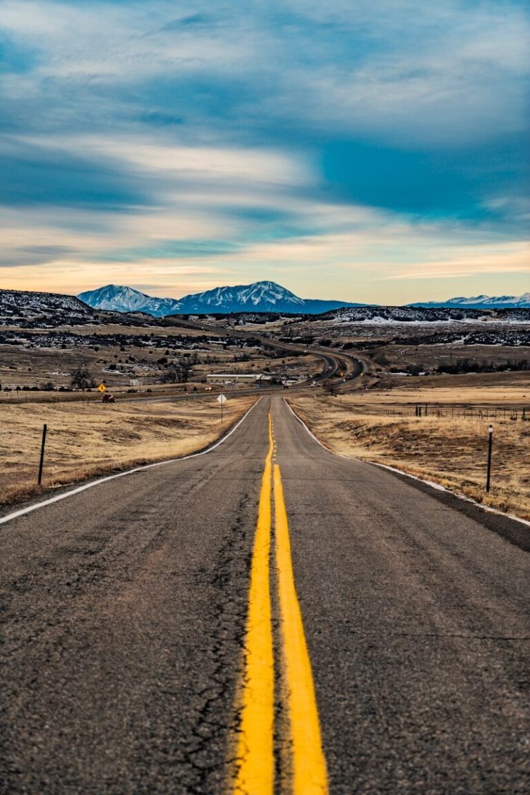 empty road under white clouds and blue sky